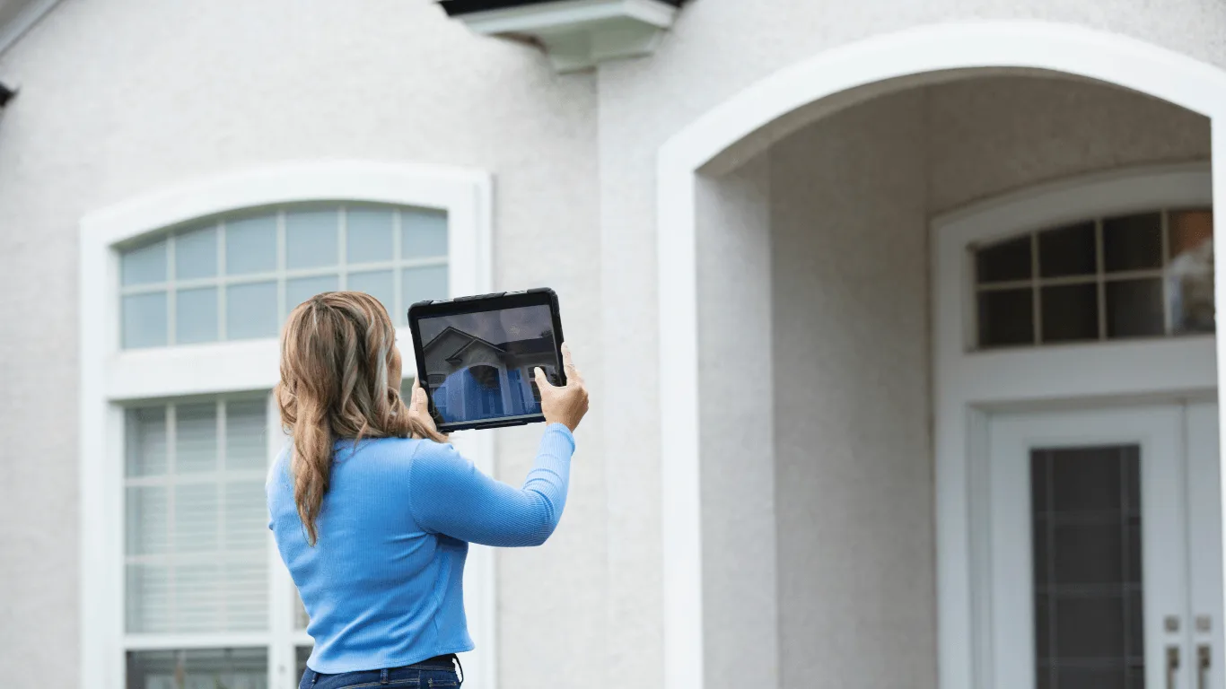 image of real valuation services appraiser taking a picture for a real estate appraisal