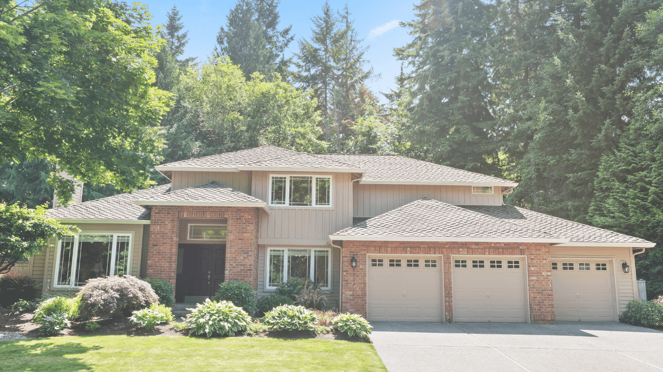 Two-story suburban house with garage and greenery.