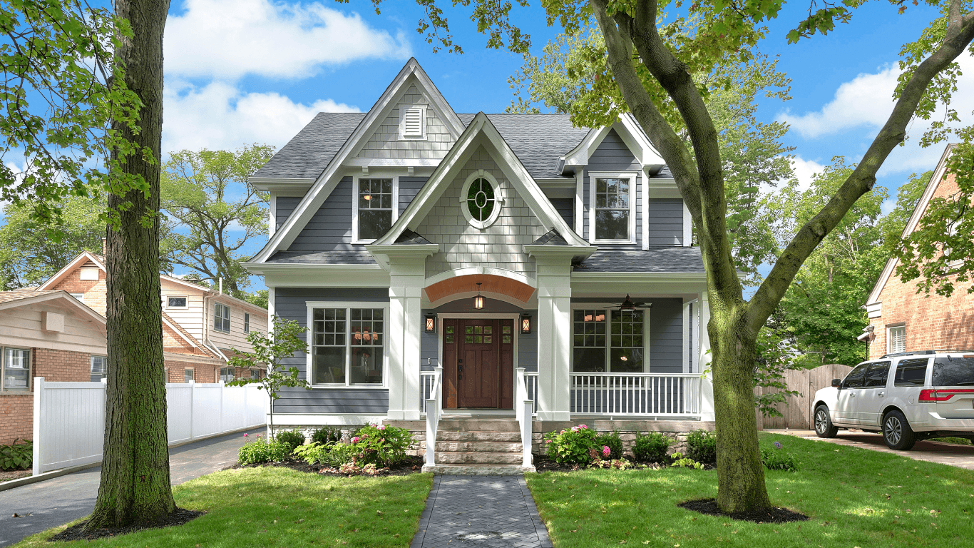 Beautiful brick house with green lawn and trees.